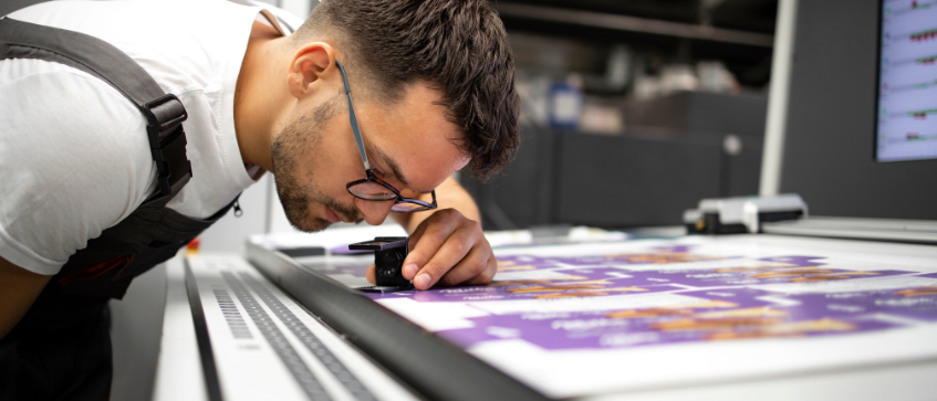 Print specialist reviewing colour consistency in print