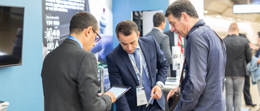 business conference attendees with display banners and marketing collaterals